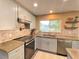 Modern kitchen with light gray cabinets, concrete countertops, and stainless steel appliances at 5381 Waving Sage Dr, Las Vegas, NV 89149