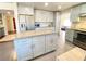 Modern kitchen with center island, stainless steel appliances, and gray cabinets at 5381 Waving Sage Dr, Las Vegas, NV 89149