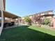 Landscaped backyard with covered patio and artificial turf at 6454 Mount Palomar Ave, Las Vegas, NV 89139