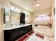 Elegant bathroom with double vanity, soaking tub, and separate shower at 6454 Mount Palomar Ave, Las Vegas, NV 89139