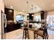 Well-equipped kitchen featuring dark cabinetry, granite island, and stainless steel appliances at 6454 Mount Palomar Ave, Las Vegas, NV 89139