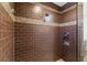 Shower with brown tile, mosaic accents, and built-in seat at 659 I, Boulder City, NV 89005