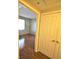 A well-lit hallway with wood floors and access to bedrooms at 6955 N Durango Dr # 1085, Las Vegas, NV 89149