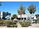 Community pool with a rock waterfall feature and surrounding landscaping at 6955 N Durango Dr # 1085, Las Vegas, NV 89149