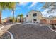 Spacious backyard with gravel landscaping, patio, and palm trees at 718 Glenwood Springs Ave, North Las Vegas, NV 89032