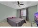 Bright bedroom with a double bed, TV, and ceiling fan at 718 Glenwood Springs Ave, North Las Vegas, NV 89032