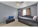 Bedroom with daybed, TV, and built-in shelving at 718 Glenwood Springs Ave, North Las Vegas, NV 89032