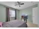 Bright bedroom with ceiling fan, window, and neutral walls at 718 Glenwood Springs Ave, North Las Vegas, NV 89032