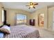 Bright bedroom with a king-size bed and ensuite bathroom access at 718 Glenwood Springs Ave, North Las Vegas, NV 89032