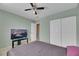 Well-lit bedroom with ceiling fan, large closet, and neutral walls at 718 Glenwood Springs Ave, North Las Vegas, NV 89032