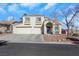 Two-story house with a two-car garage and nicely landscaped front yard at 718 Glenwood Springs Ave, North Las Vegas, NV 89032