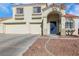 Two-story house featuring a blue front door and attached two-car garage at 718 Glenwood Springs Ave, North Las Vegas, NV 89032