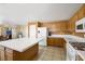 Kitchen with island, wood cabinets and appliances at 718 Glenwood Springs Ave, North Las Vegas, NV 89032