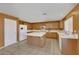 Kitchen features wood cabinets, white appliances, and an island at 718 Glenwood Springs Ave, North Las Vegas, NV 89032