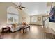 Bright living room with hardwood floors, a sofa, and large windows at 718 Glenwood Springs Ave, North Las Vegas, NV 89032