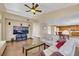 Living room with hardwood floors and a large TV at 718 Glenwood Springs Ave, North Las Vegas, NV 89032