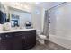 Clean bathroom with dark vanity, shower/tub combo, and tile floor at 7563 Chimney Point Ct, Las Vegas, NV 89166