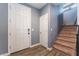 Entryway with front door, coat closet, and carpeted stairs at 7563 Chimney Point Ct, Las Vegas, NV 89166