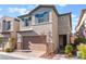 Two-story house with attached garage and landscaped front yard at 7563 Chimney Point Ct, Las Vegas, NV 89166