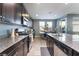 Well-equipped kitchen with dark wood cabinets and granite countertops at 7563 Chimney Point Ct, Las Vegas, NV 89166