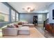 Spacious living room featuring a sectional sofa and wood floors at 7563 Chimney Point Ct, Las Vegas, NV 89166