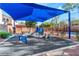 Community playground with shaded play area and slide at 7563 Chimney Point Ct, Las Vegas, NV 89166