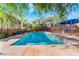 Community swimming pool with lounge chairs and shade at 7563 Chimney Point Ct, Las Vegas, NV 89166