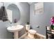 Updated powder room with pedestal sink and stylish vanity at 7563 Chimney Point Ct, Las Vegas, NV 89166