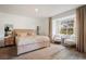 Bright bedroom with a plush bed, wooden furniture, and a view of the backyard at 796 Tam O Shanter, Las Vegas, NV 89109