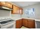 Galley kitchen with light wood cabinets and white appliances at 796 Tam O Shanter, Las Vegas, NV 89109