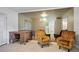 Bright living room with two mustard armchairs and a vintage desk at 796 Tam O Shanter, Las Vegas, NV 89109