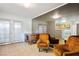 Bright living room with two mustard armchairs and a vintage desk at 796 Tam O Shanter, Las Vegas, NV 89109