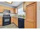 Modern kitchen with granite countertops, black appliances, and light wood cabinets at 833 Aspen Peak Loop # 2524, Henderson, NV 89011