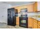 Well-equipped kitchen featuring black appliances and granite counters at 833 Aspen Peak Loop # 2524, Henderson, NV 89011