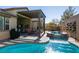 Luxury backyard with a sparkling pool, hot tub, and covered patio at 8435 Great Outdoors St, Las Vegas, NV 89166