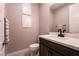 Modern powder room with dark vanity and quartz countertop at 8435 Great Outdoors St, Las Vegas, NV 89166