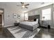 Spacious bedroom with king-size bed and gray upholstered headboard at 8435 Great Outdoors St, Las Vegas, NV 89166