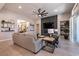 Living area with comfortable seating, a stone fireplace, and views into the kitchen at 8435 Great Outdoors St, Las Vegas, NV 89166