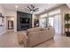 Living room showcasing a stone fireplace, large windows, and comfortable seating at 8435 Great Outdoors St, Las Vegas, NV 89166