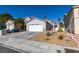 Single-story home with a two-car garage and landscaped front yard at 8712 Majestic Pine Ave, Las Vegas, NV 89143