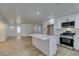 Modern kitchen with white cabinets, quartz countertops, and stainless steel appliances at 8712 Majestic Pine Ave, Las Vegas, NV 89143