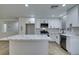 Renovated kitchen featuring white cabinets and a large quartz island at 8712 Majestic Pine Ave, Las Vegas, NV 89143