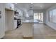 Bright kitchen featuring white cabinets, a large island, and vinyl flooring at 8712 Majestic Pine Ave, Las Vegas, NV 89143