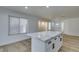 Modern kitchen with white cabinets, a large island, and luxury vinyl plank flooring at 8712 Majestic Pine Ave, Las Vegas, NV 89143