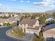 Two-story house with a three car garage, and a community view at 8728 Burning Hide Ave, Las Vegas, NV 89143