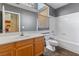 Clean bathroom with a bathtub, toilet, and wood vanity at 8728 Burning Hide Ave, Las Vegas, NV 89143