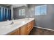 Clean bathroom with double sinks and wood cabinets at 8728 Burning Hide Ave, Las Vegas, NV 89143