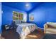 Bright bedroom with a double bed and blue walls at 8728 Burning Hide Ave, Las Vegas, NV 89143