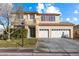 Two-story house with a three-car garage and landscaped front yard at 8728 Burning Hide Ave, Las Vegas, NV 89143