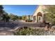 Landscaped backyard with a stone bridge and desert plants at 8821 Sandspring Dr, Las Vegas, NV 89134